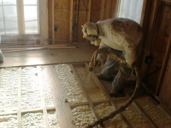 Cellulose insulation in Atlanta GA being blown into a floor and wall cavity