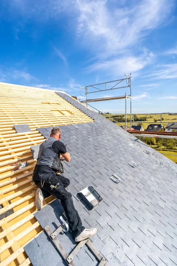 Roof repair in Atlanta GA with a technician working on shingles